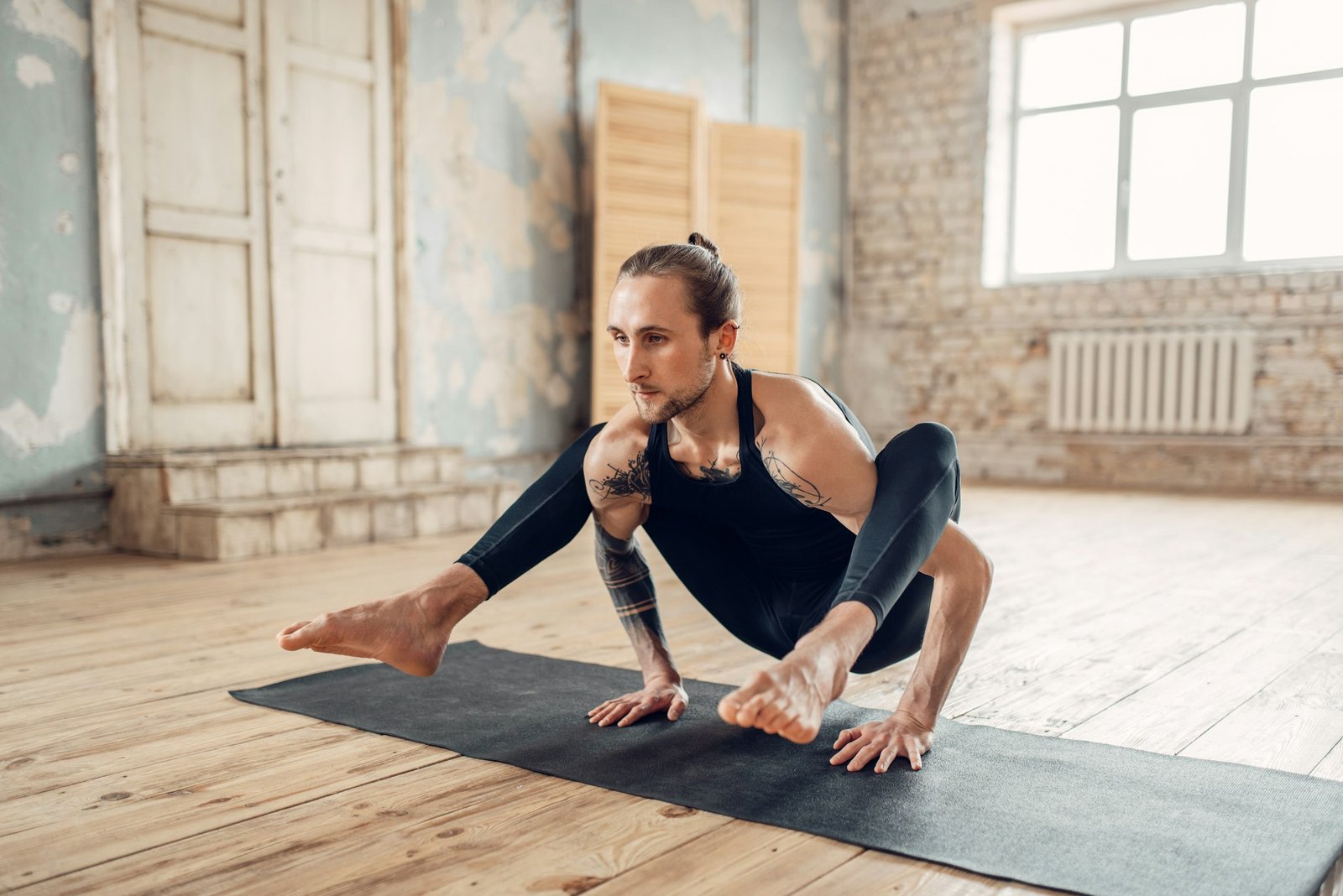 Male yoga in class, balance training